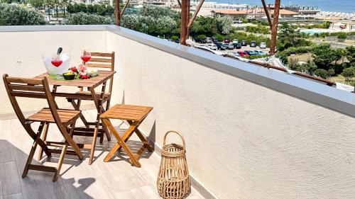 a table and chairs on a balcony with a view at Rooftop Blu Infinito e Dolce Naufragio by Ca-Sa Check in Chioggia