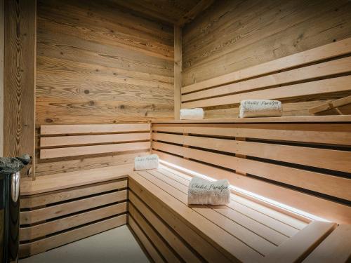 a wooden sauna with two seats in it at Chalet Paralpin - OVO Network in Manigod