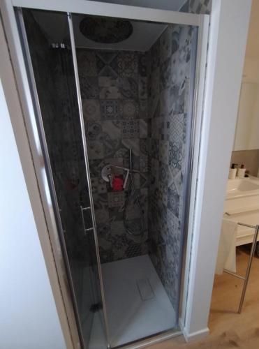 a shower with a glass door in a room at Casa vacanza del Cavallo in Senigallia