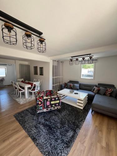 a living room with a couch and a table at Vila Botanic Residence in Sarajevo