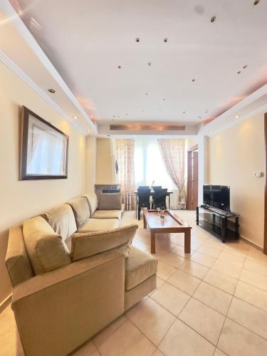 a living room with a couch and a piano at Family Beach apartment in Perea