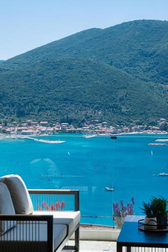 a balcony with a view of a large body of water at Azzura villas in Vasiliki