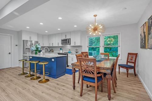 a kitchen and dining room with a table and chairs at Southern Storm - Modern Stay with Patio & Yard home in Wilmington