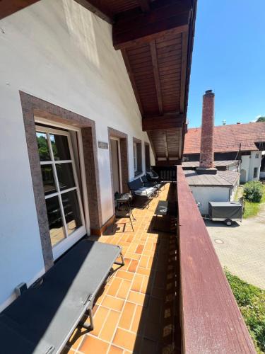 a porch of a house with benches on it at Timos Dahoam 93qm Balkon und familienfreundlich in Nesselwang