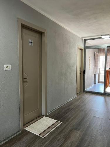 an empty room with a door and a hallway at Vila L&D in Pogradec