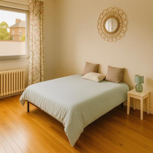 - un lit dans une chambre avec un miroir et une fenêtre dans l'établissement Duplex lumineux 4 chambres et 2 SDB proche gare, à Angers