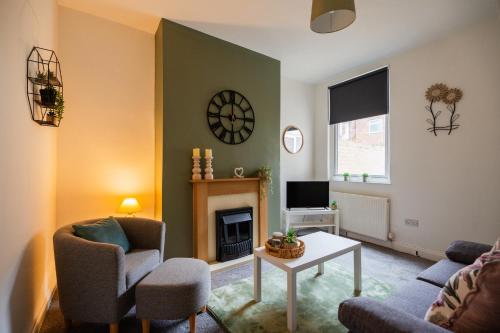 a living room with a couch and a fireplace at The Alfred Suite in Redcar
