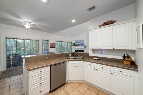 a kitchen with white cabinets and a sink at 2882 Old Drake in Seabrook Island