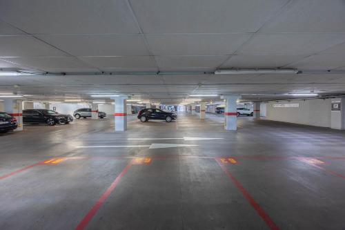 an empty parking garage with cars parked in it at iH Hotels Milano Gioia in Milan