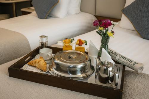 a tray with food and drinks on a bed at Grand Hotel Tralee in Tralee