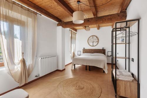 a bedroom with a bed and a large window at Il Serraglio Rooms in Valeggio sul Mincio