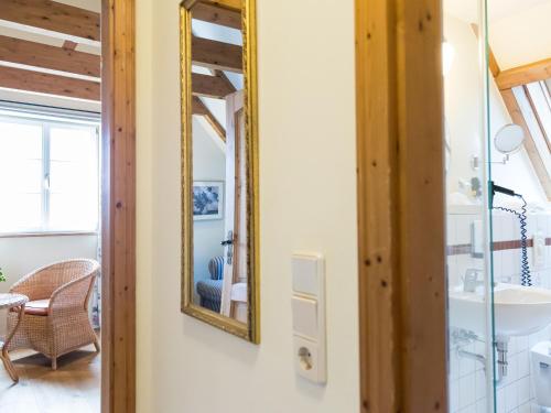 a bathroom with a mirror and a sink in a room at Landhaus Alte Schmiede in Niemegk