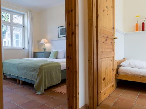 a bedroom with two beds and a window at Landhaus Alte Schmiede in Niemegk