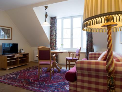a living room with a couch and a table at Landhaus Alte Schmiede in Niemegk