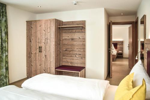 a bedroom with a wooden wall and a bed at Lisas Schröcken in Schröcken