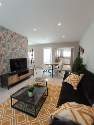 a living room with a couch and a table at Appartement T2 NEUF CENTRE VILLE in Concarneau