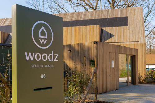 a building with a sign in front of it at Lodge met Jacuzzi - 4 personen - Woodz Lodges in Heusden - Zolder