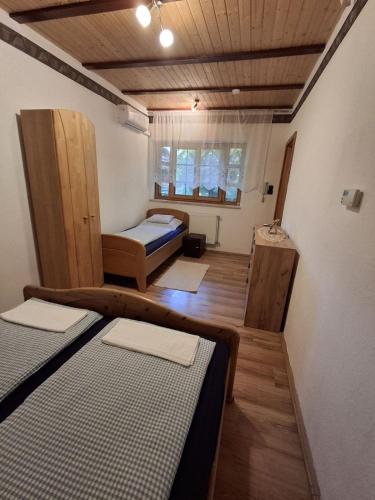 a small room with two beds in a room at Faludi vendégház in Vonyarcvashegy