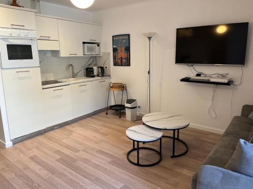 a living room with a couch and a kitchen at 4 People Cannes Hyper Centre and Air conditioning in Cannes