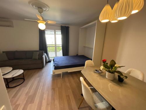 a living room with a bed and a dining table at 4 People Cannes Hyper Centre and Air conditioning in Cannes