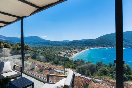 a view of a beach from the balcony of a house at Azzura villas in Vasiliki