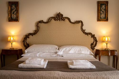 a bed with two pillows on it with two lamps at Sant'Ivo Apartments in Rome