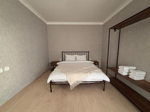 a bedroom with a bed and a mirror at Geo Inn in Stepantsminda