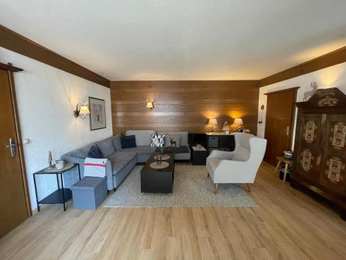 a living room with a couch and a table at Charming apartment Berggeweih Lodge at Zwölferkogel in Hinterglemm in Größing