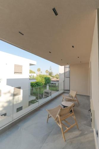 a living room with a chair and a table at Theros Kourouta Boutique Hotel in Kourouta