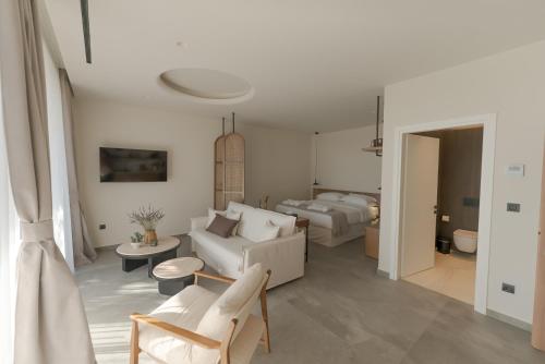 a living room with two beds and a couch at Theros Kourouta Boutique Hotel in Kourouta