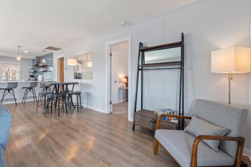 a living room and kitchen with a table and chairs at Now Youre Cookin in Duck