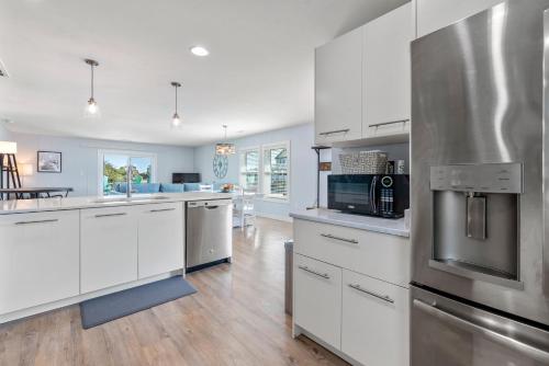 a kitchen with white cabinets and stainless steel appliances at Now Youre Cookin in Duck