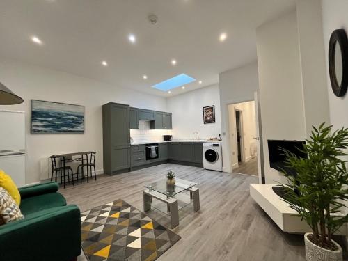 a living room with a couch and a table at The Coastal Getaway in Isle of Wight