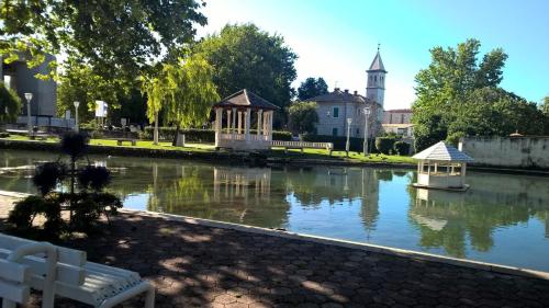 a river with a gazebo and a boat in it at Apartments Jasminka in Solin