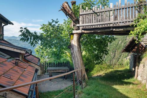 a wooden bridge over a yard next to a house at Rielingerhof in Collalbo