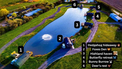an aerial view of a river with boats in the water at The Firs Country Park in Boston