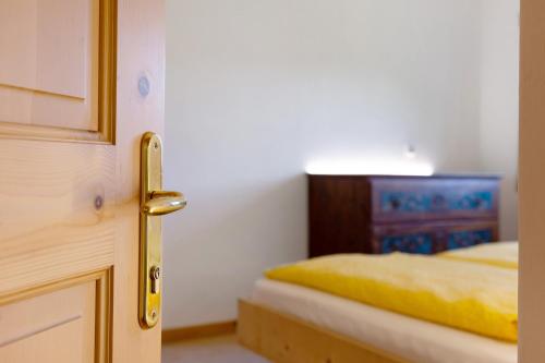 a door open to a bedroom with a bed at Rielingerhof in Collalbo