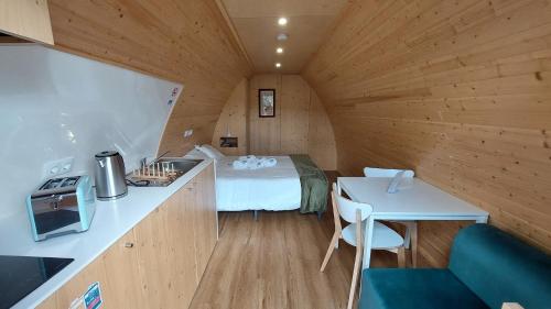 a small room with a bed and a kitchen in a cabin at Green Paradise Glamping in Covas