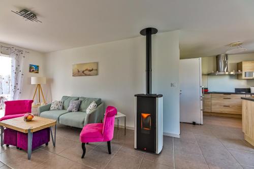 - un salon avec un canapé et une cuisinière dans l'établissement Le Dôme - Piscine - Parking - Jardin, à Commequiers