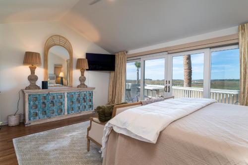 a bedroom with a large bed and a large window at 3145 Green Heron Court in Seabrook Island