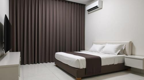 a bedroom with a bed and a brown curtain at Punarvika Bay Villa in Puttalam