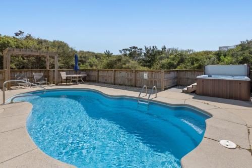 Southern ShoresにあるOcean Havenの木製のフェンスの隣にあるパティオのプール