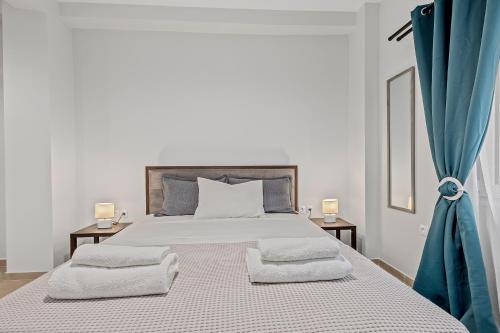 a bedroom with a large bed with two pillows on it at Athens Urban Lifestyle Apartments in Athens