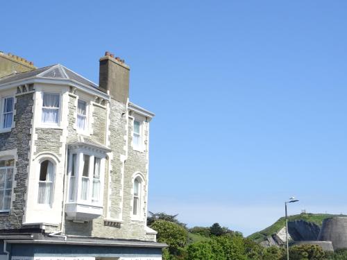 an old stone house on the side of the road at Puffins Nest, close to Tunnels Beach & Harbour with Parking in Ilfracombe