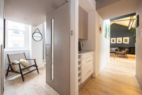 a kitchen with a door leading to a living room at Central and Quirky Northern Quarter Flat, Manchester in Manchester