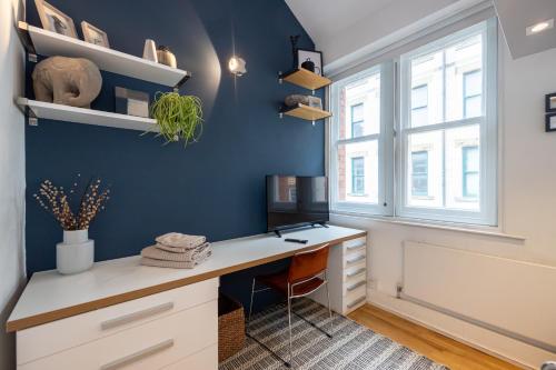 a home office with a desk and a window at Central and Quirky Northern Quarter Flat, Manchester in Manchester