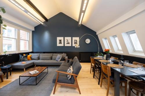 a living room with a couch and a table at Central and Quirky Northern Quarter Flat, Manchester in Manchester