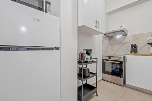 a kitchen with white walls and white appliances at Athens Urban Lifestyle Apartments in Athens