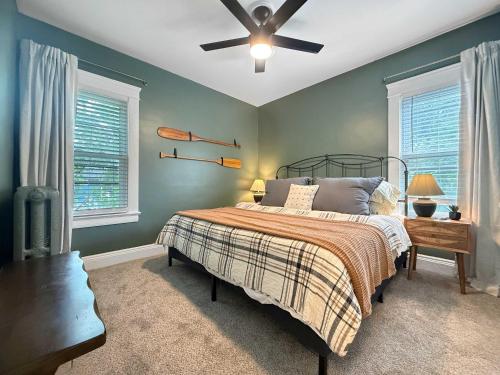 a bedroom with a bed and a ceiling fan at Chic Lakeside Retreat Steps from the Beach in Cleveland