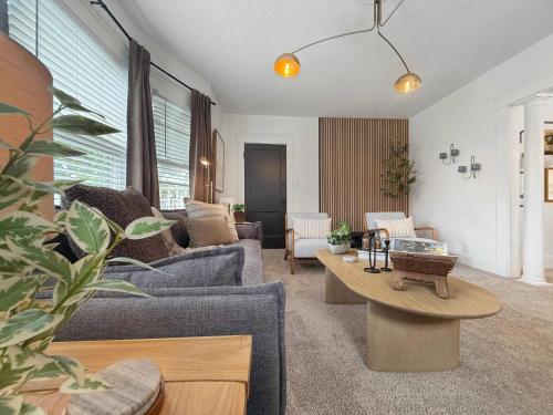 a living room with a couch and a table at Chic Lakeside Retreat Steps from the Beach in Cleveland